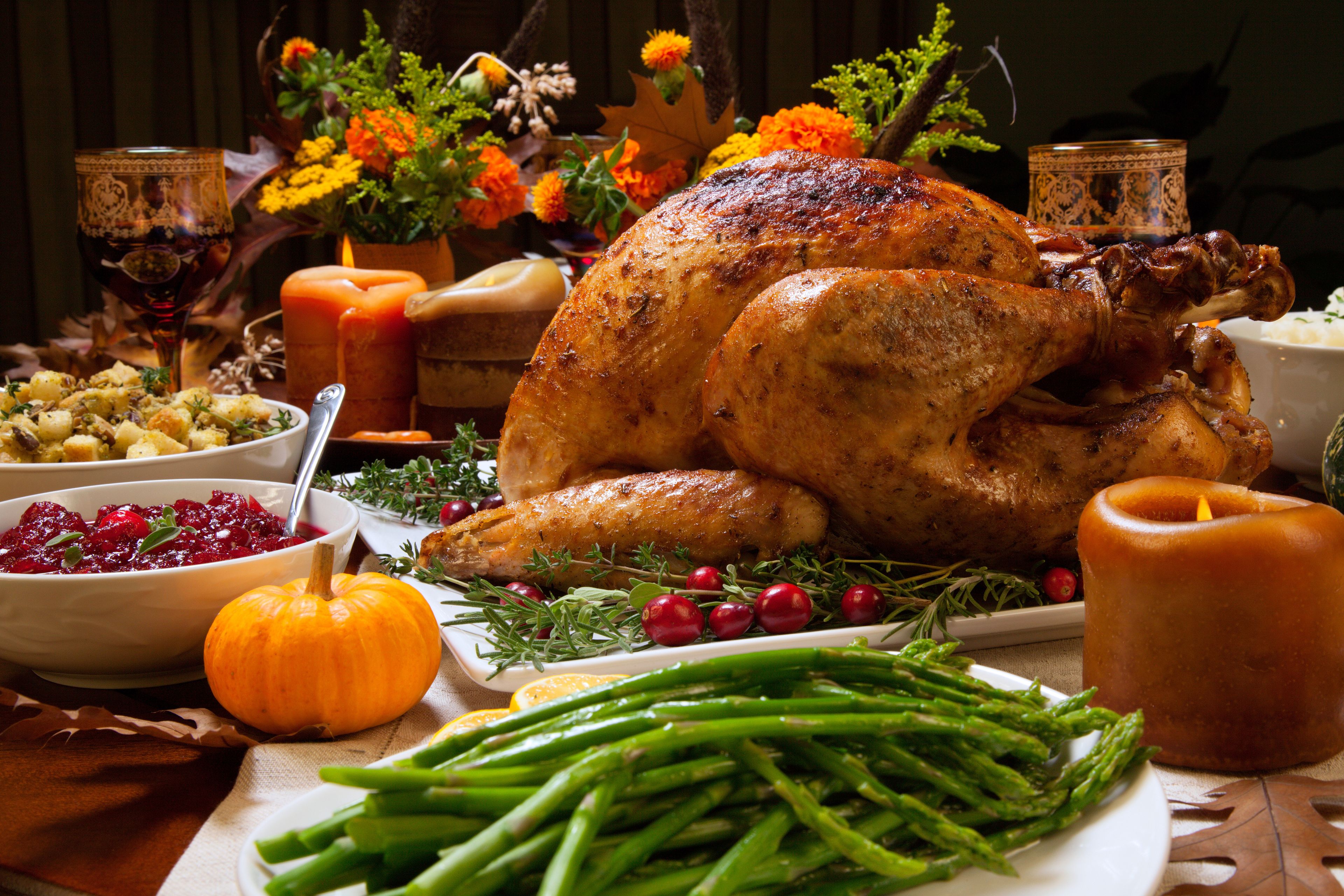A roasted turkey surrounded by various side dishes and decorations.