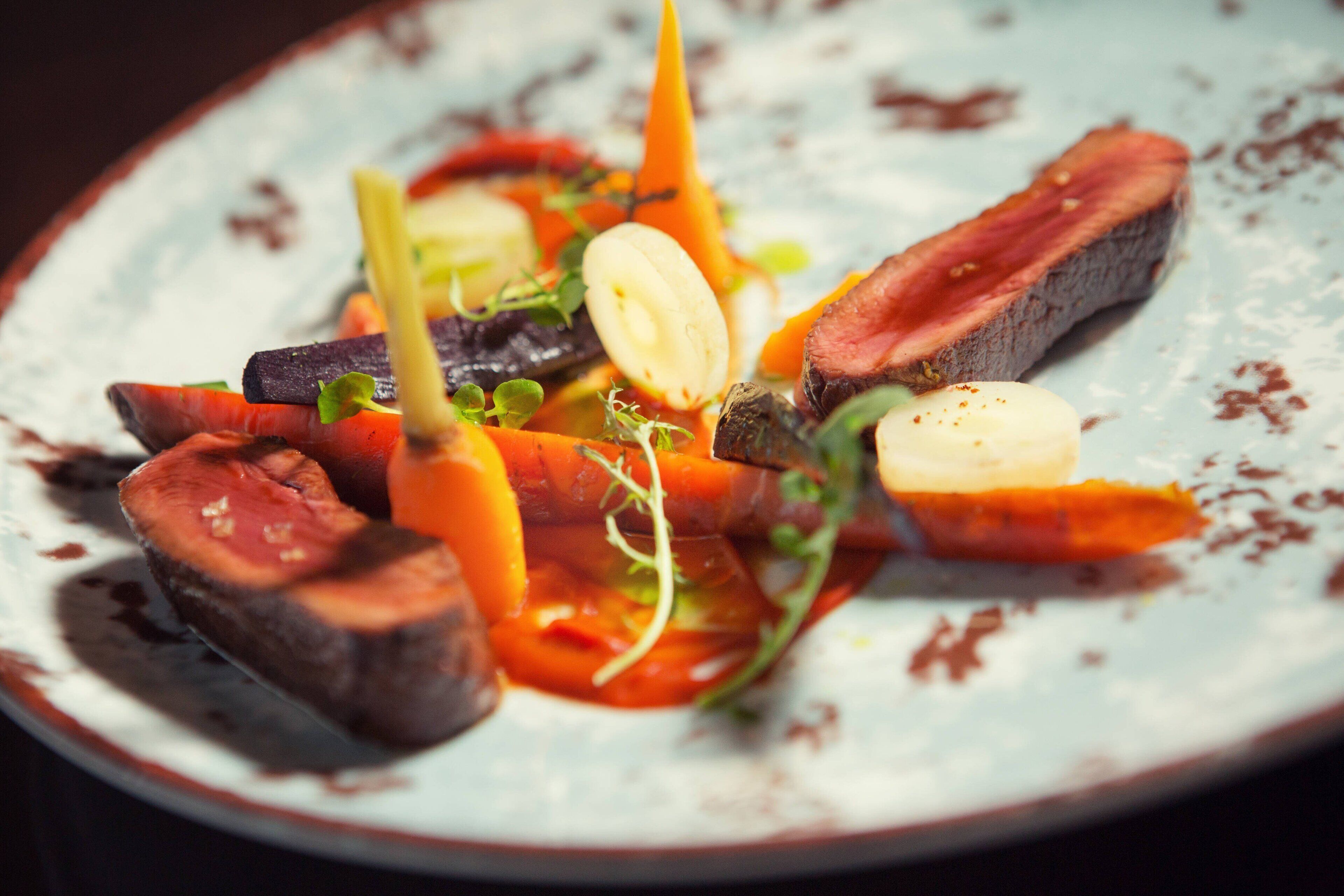 A plate of food with various vegetables and meat.