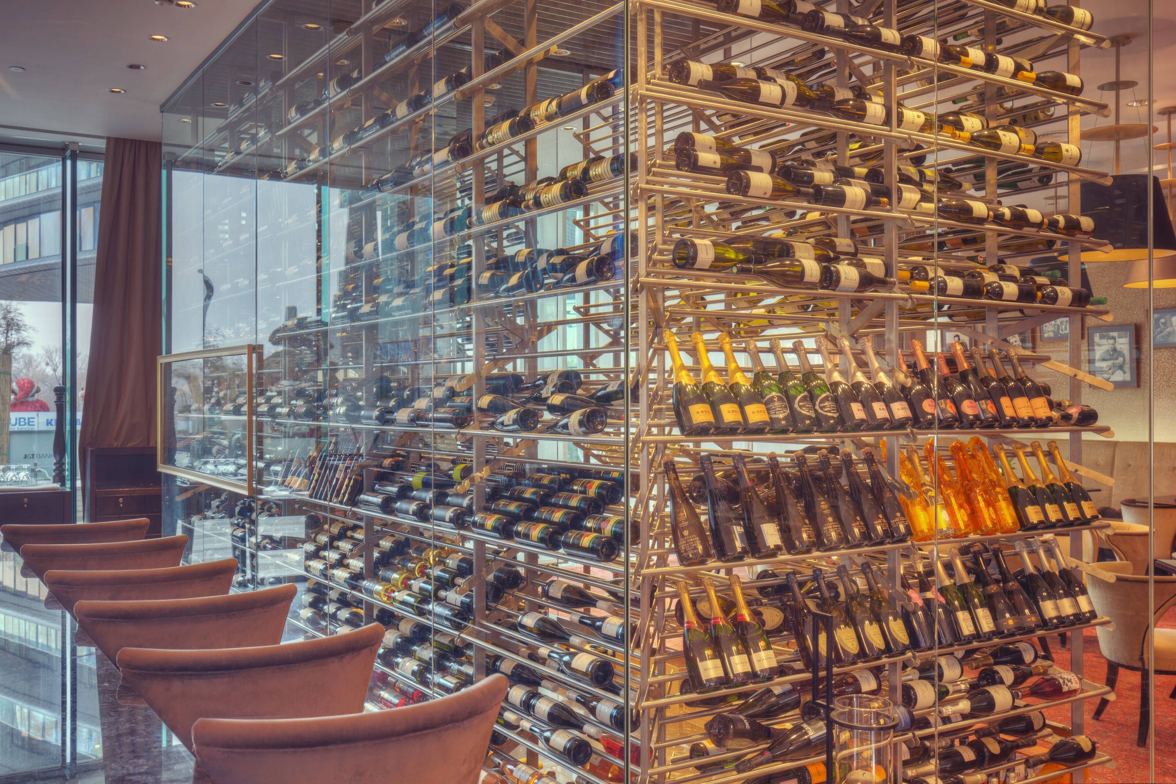A wine cellar with numerous wine racks and a few chairs.