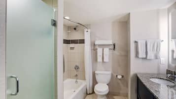 A modern bathroom with a bathtub, toilet, and sink.
