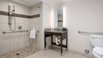 A modern bathroom with a shower, toilet, and sink.