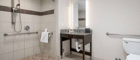Un baño moderno con ducha, inodoro y lavamanos.