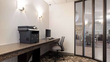 A modern office space with a desk, computer, and chair.