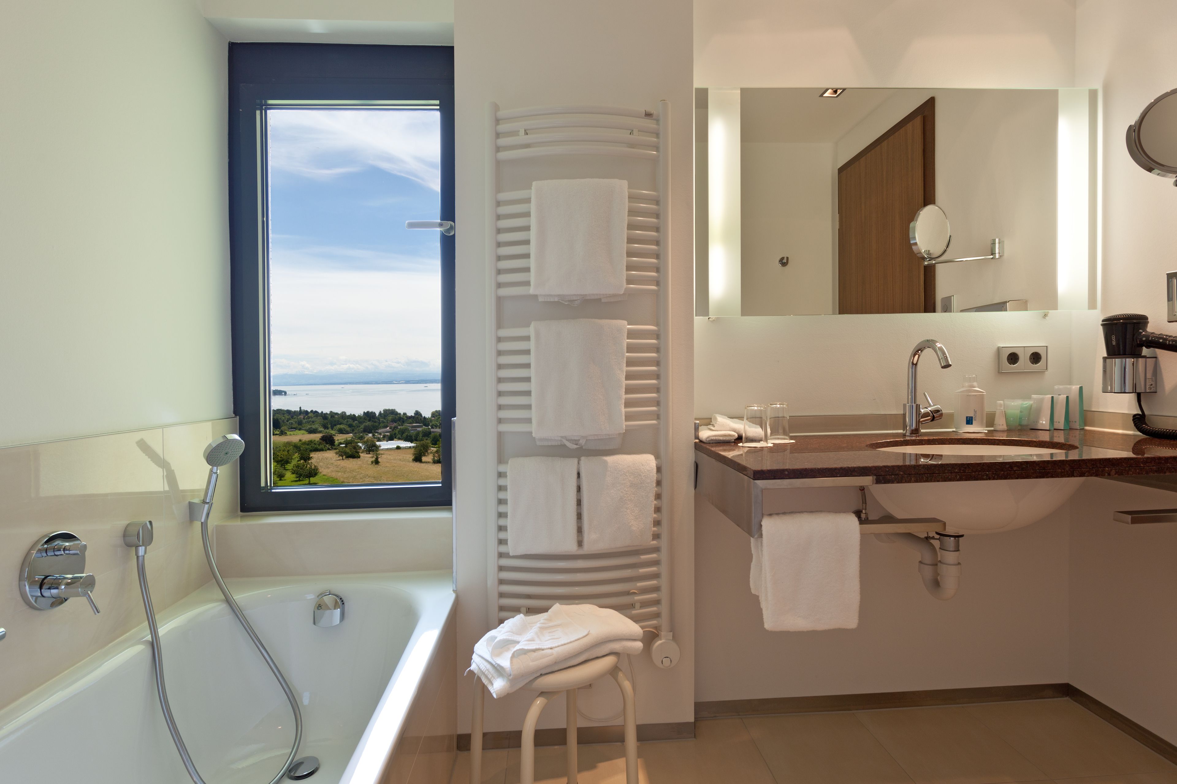 panoramic double room, lake view | bathroom | free toiletries, hair dryer, bathrobes, slippers