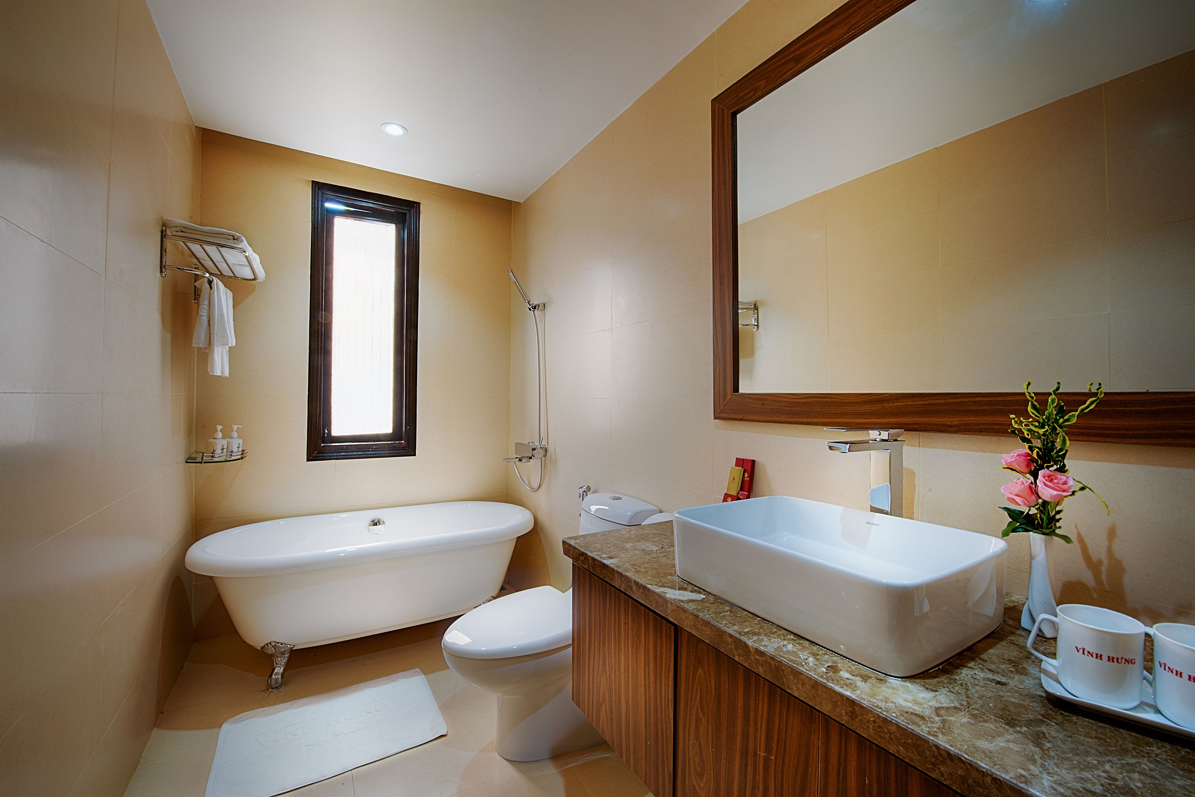 deluxe room | bathroom | shower, rainfall showerhead, hair dryer, slippers