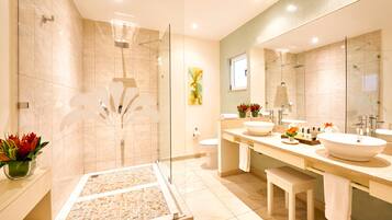 A modern bathroom with a glass-enclosed shower, two sinks, and a large mirror.