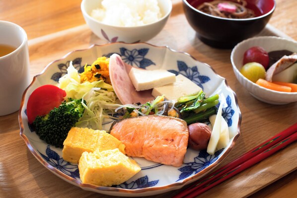 A plate of food with various items including fish, vegetables, and tofu.