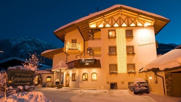 A multi-story building with a sign reading "Restaurant" and "Loipenstuben." - Loipenstub'n (Brixen im Thale)