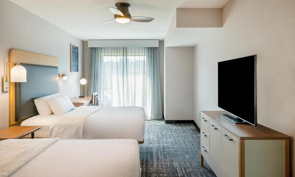 A hotel room with two beds, a flat-screen TV, a ceiling fan, and a large window with curtains. - Homewood Suites by Hilton Pittsburgh Southpointe (Canonsburg)