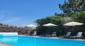 Seasonal outdoor pool, open 9:00 AM to 8:00 PM, pool umbrellas