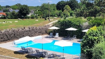 Seasonal outdoor pool, open 9:00 AM to 8:00 PM, pool umbrellas