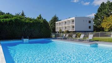 Seasonal outdoor pool, open 9:00 AM to 8:00 PM, pool umbrellas