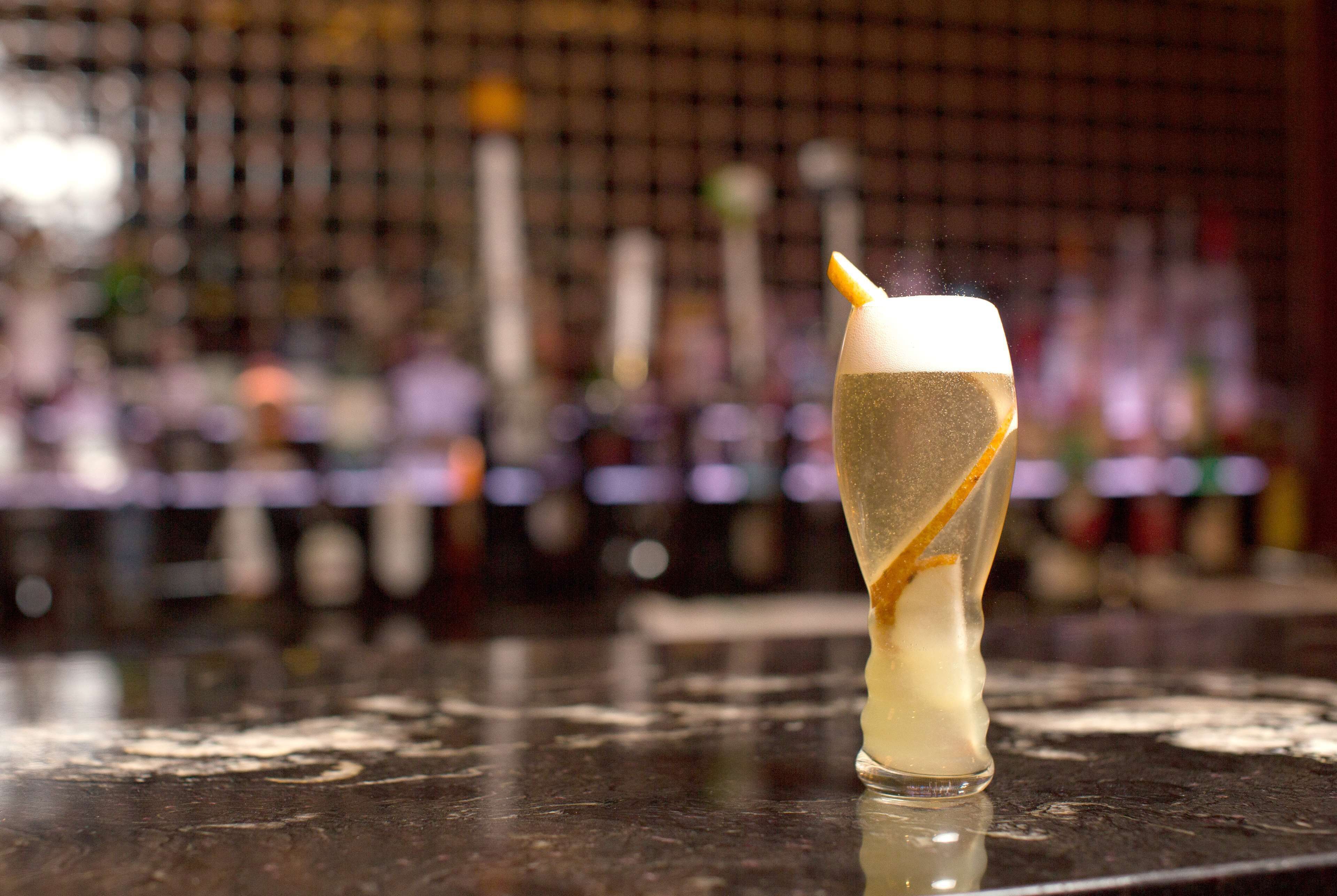 A cocktail with a unique presentation on a bar counter.
