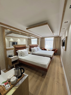 Triple Room | Minibar, in-room safe, desk, iron/ironing board