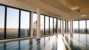 A spacious interior with large windows offering a view of the outdoors.