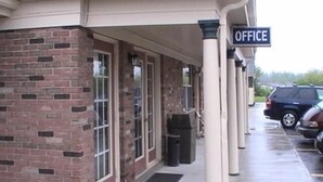 A building with a sign reading "OFFICE" and a brick facade. - Hometown Inn Galion (Galion)