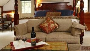 A bedroom with a four-poster bed, a wooden desk, and a green chest labeled "Bristol Navigation and Shipping Company." - Captain's House Inn (Chatham)
