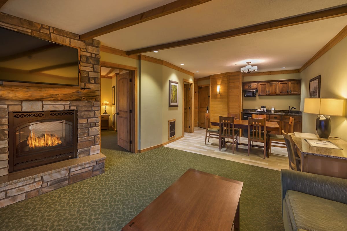 room, 1 king bed with sofa bed, jetted tub | living area | 49-inch flat-screen tv with satellite channels, tv, fireplace