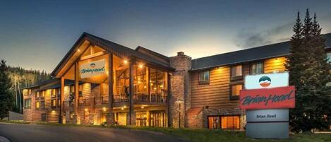 A two-story log cabin-style building with a prominent sign reading "Brian Head."