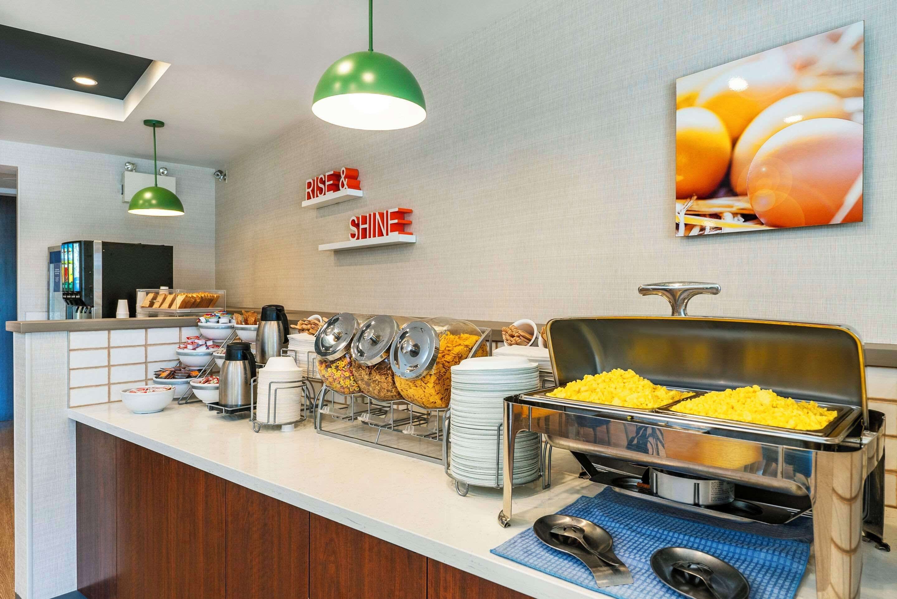 A buffet setup with various food items and a coffee station.