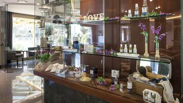 A hotel reception area with a glass display case containing toiletries and a sign that reads "LOVE".
