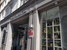 The exterior of the Passiflora Hotel with large windows and a sign indicating a 4-star rating.