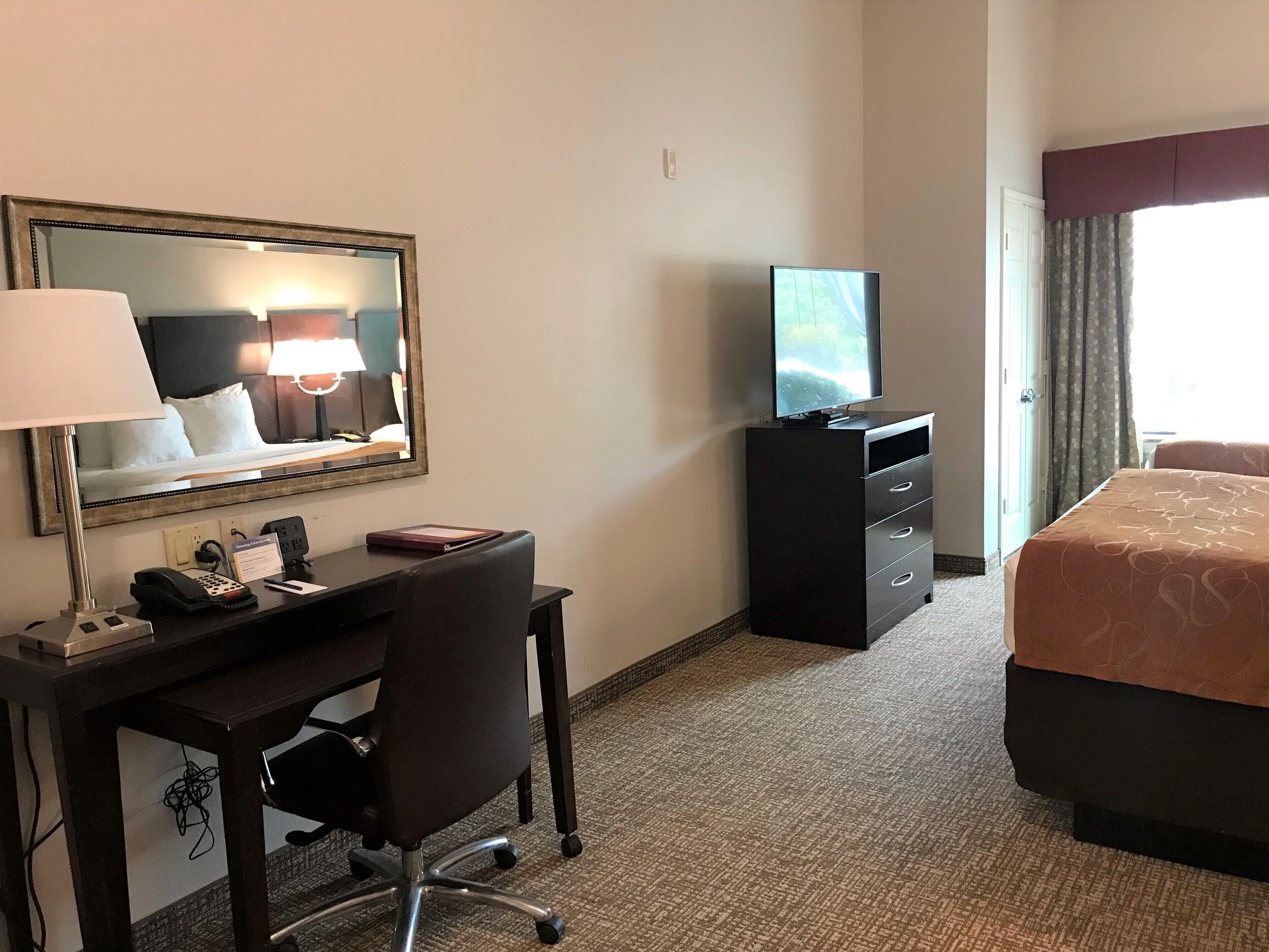 hypo-allergenic bedding, desk, laptop workspace, blackout curtains