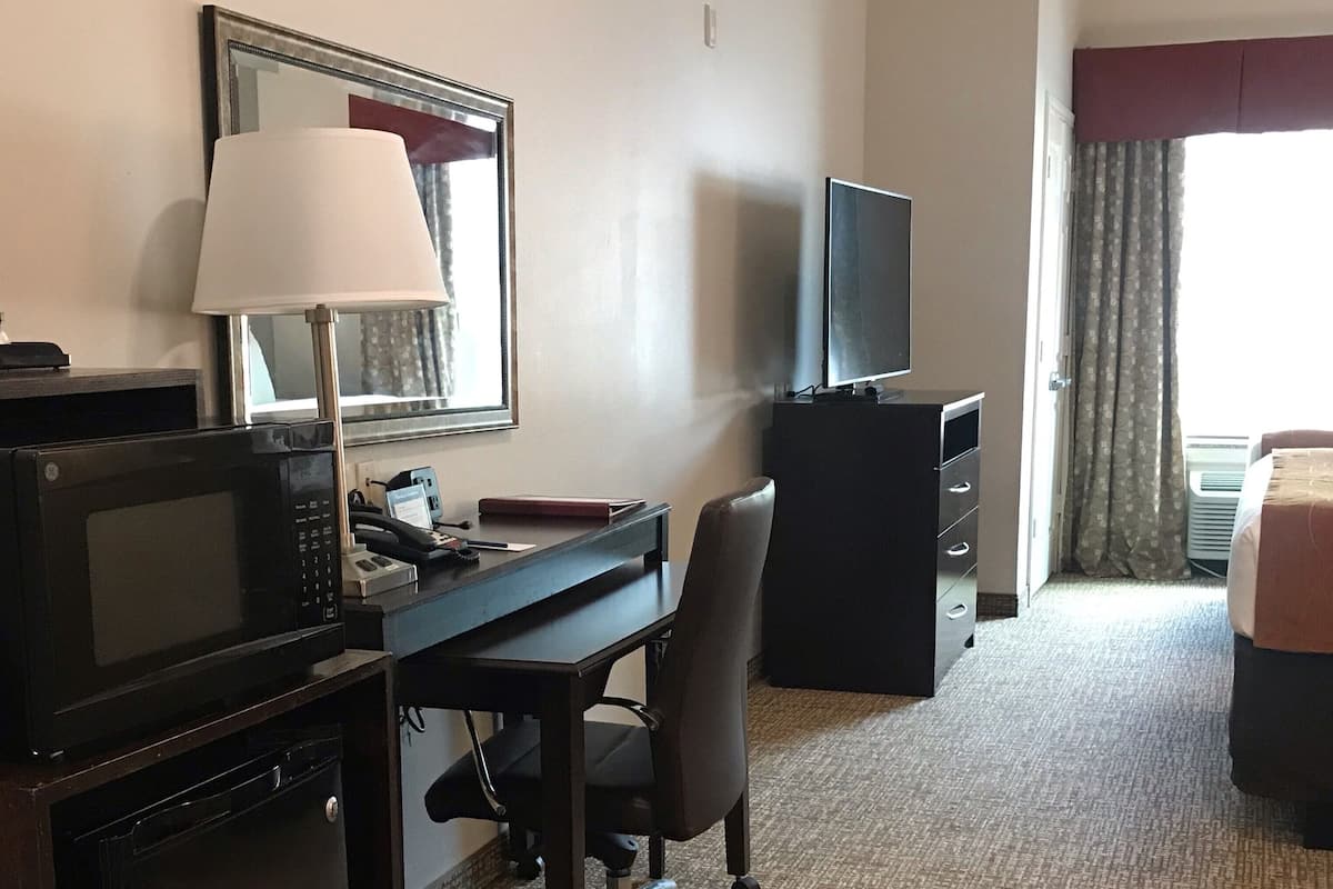 hypo-allergenic bedding, desk, laptop workspace, blackout curtains