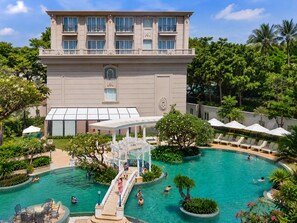 A hotel with a large pool, outdoor seating, and lush greenery. - The IMPERIAL Vung Tau Hotel (Ho Chi Minh City)
