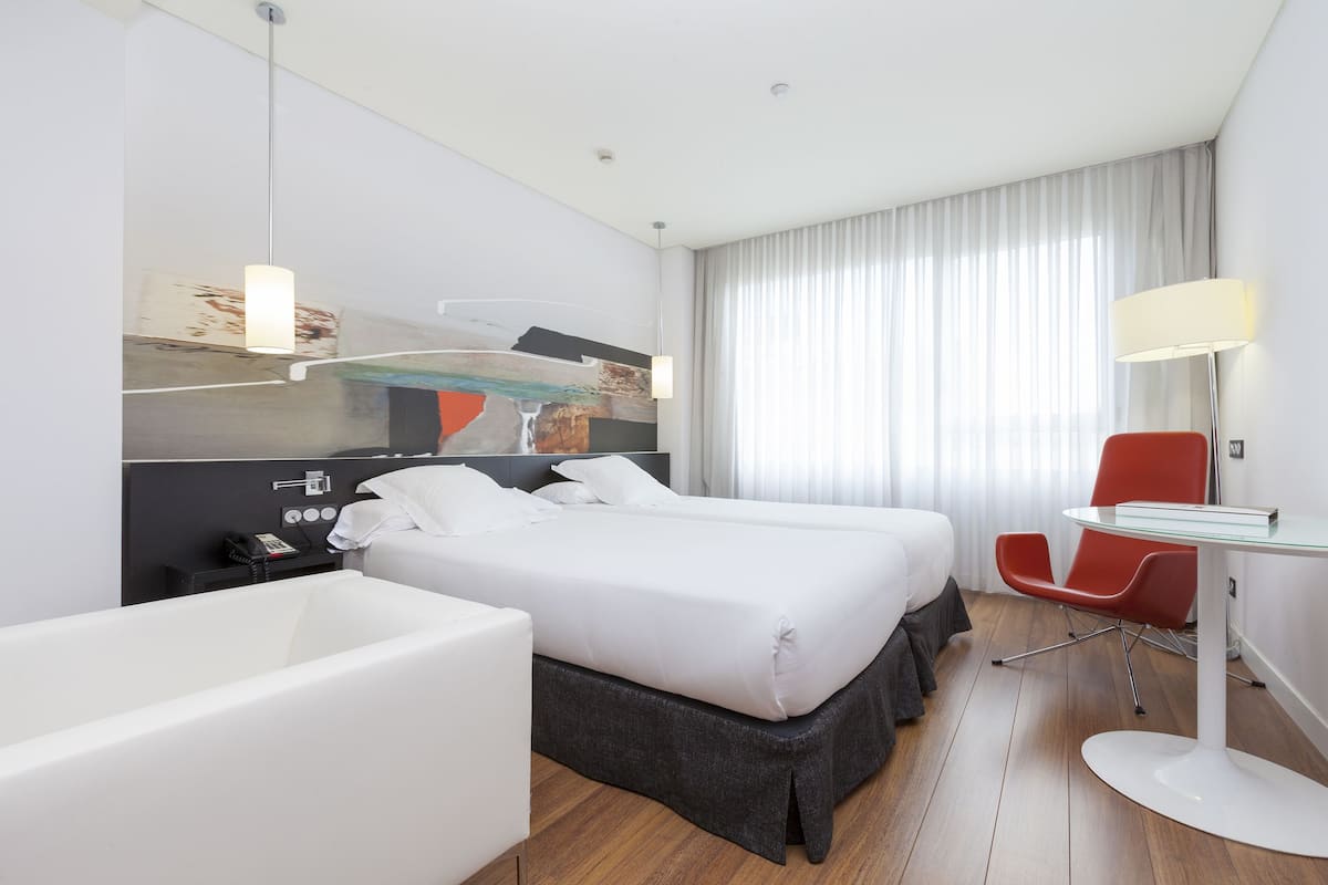 Habitación ejecutiva | Ropa de cama de alta calidad y minibar
