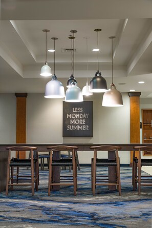 A conference room with a long table, multiple chairs, and pendant lighting. A motivational quote is displayed on the wall. - Fairfield Inn & Suites South Boston (South Boston)