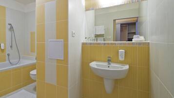A bathroom with a bathtub, toilet, and sink.