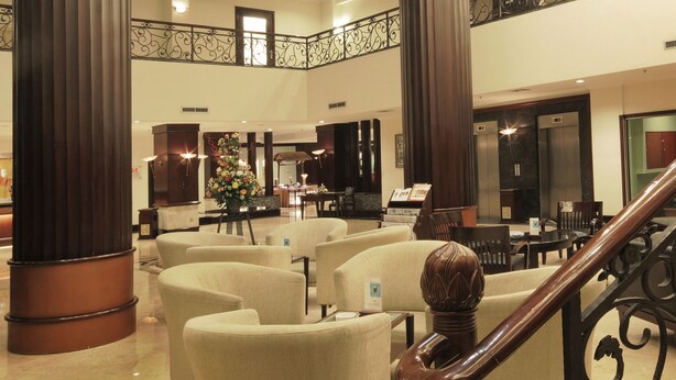 A spacious lobby with high ceilings, large columns, and a central seating area with sofas. - Swiss-Belhotel Tarakan (Tarakan)