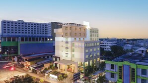 A multi-story hotel with a modern design, featuring a mix of rectangular and square windows, and a prominent entrance with a covered area. - Swiss-Belhotel Tarakan (Tarakan)