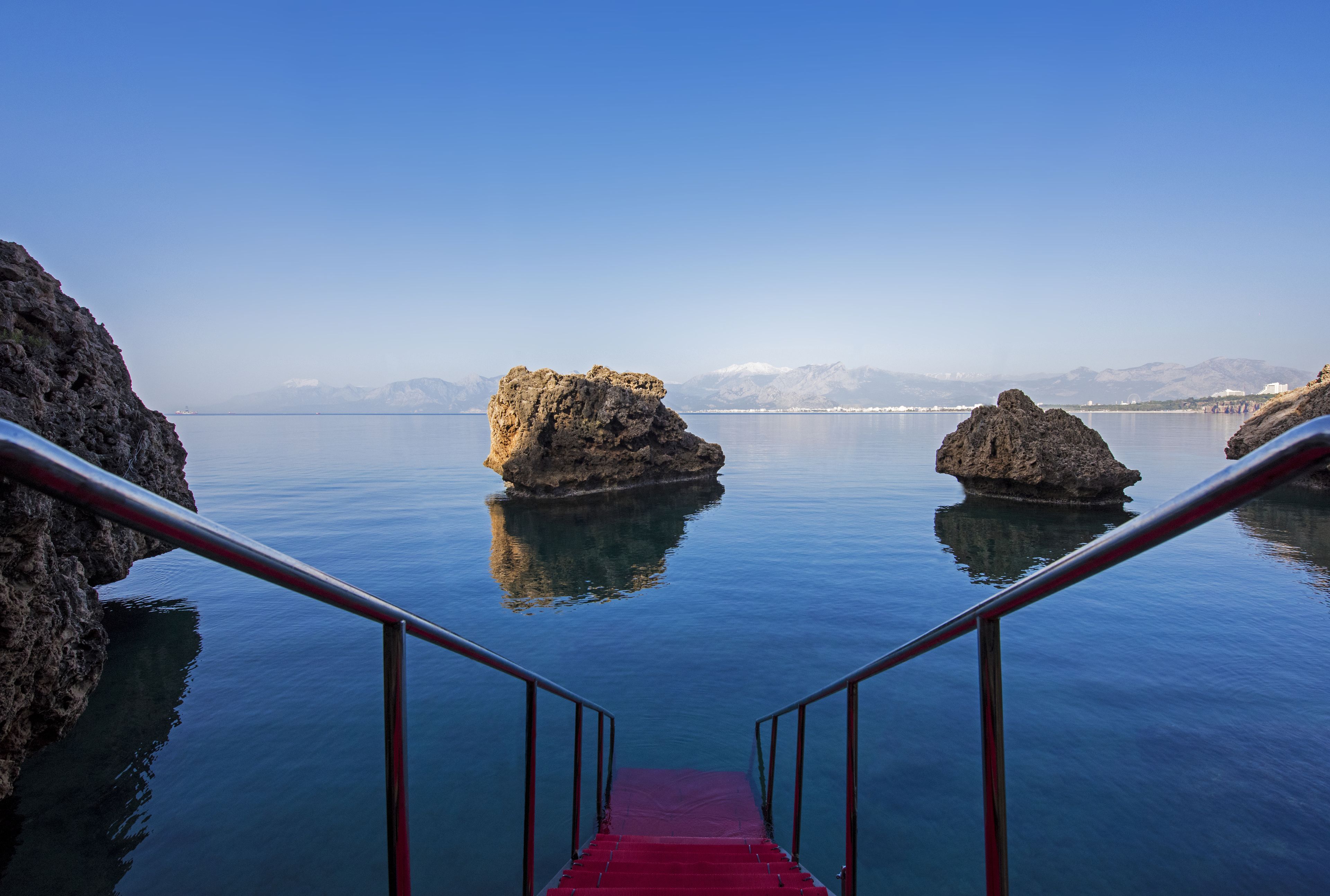 on the beach, sun-loungers, beach umbrellas, beach towels
