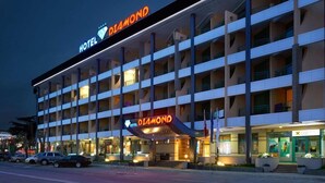 A multi-story hotel with a prominent 'HOTEL DIAMOND' sign, featuring a modern architectural design with balconies and a well-lit entrance. - Diamond Hotel (Sunny Beach)
