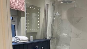 Une salle de bain moderne avec une douche à parois de verre, un meuble-lavabo et des toilettes.