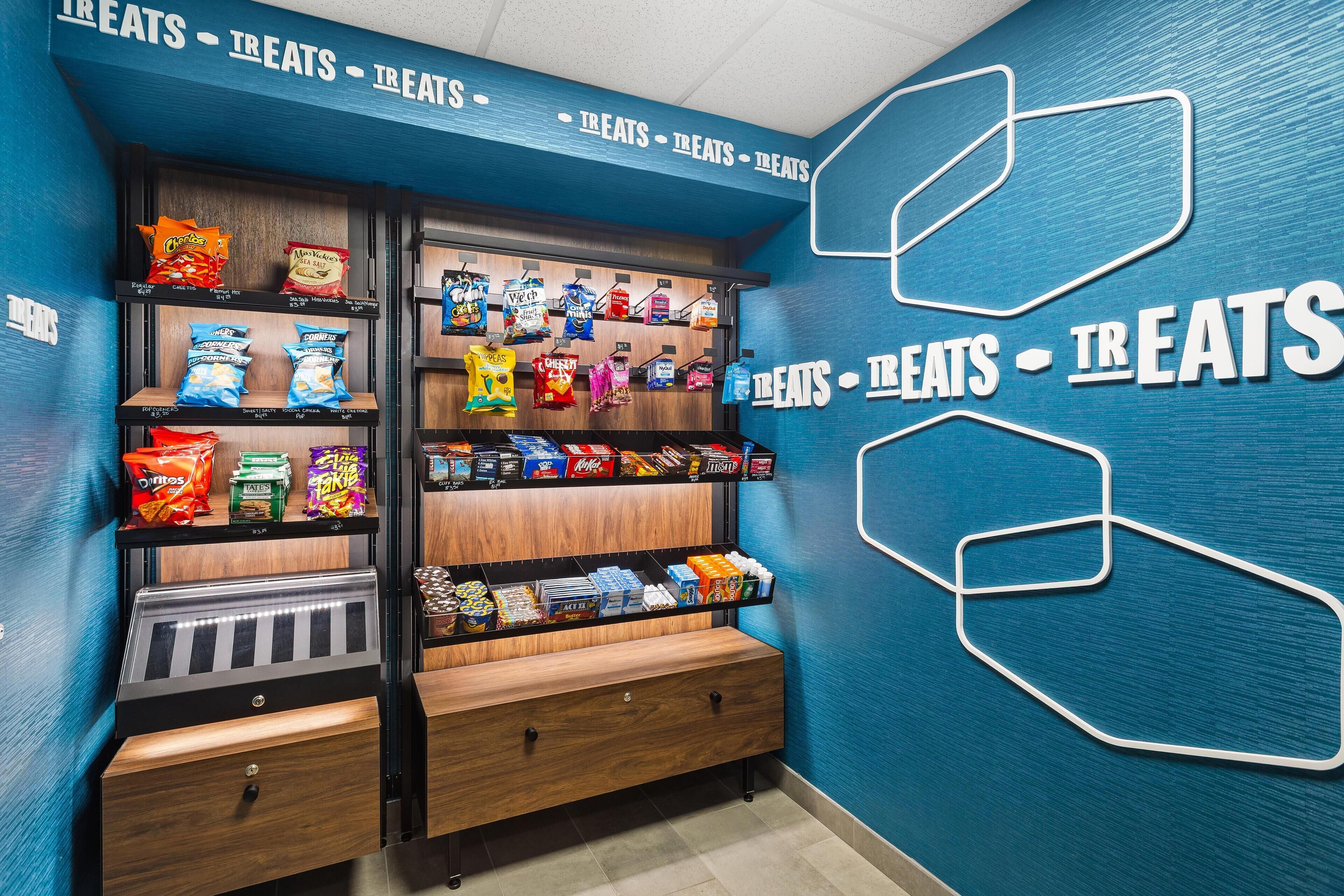 A snack display with various packaged treats and a wooden counter.