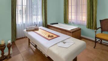 Cozy retreat with a single bed, wooden bench, and comfortable seating area.