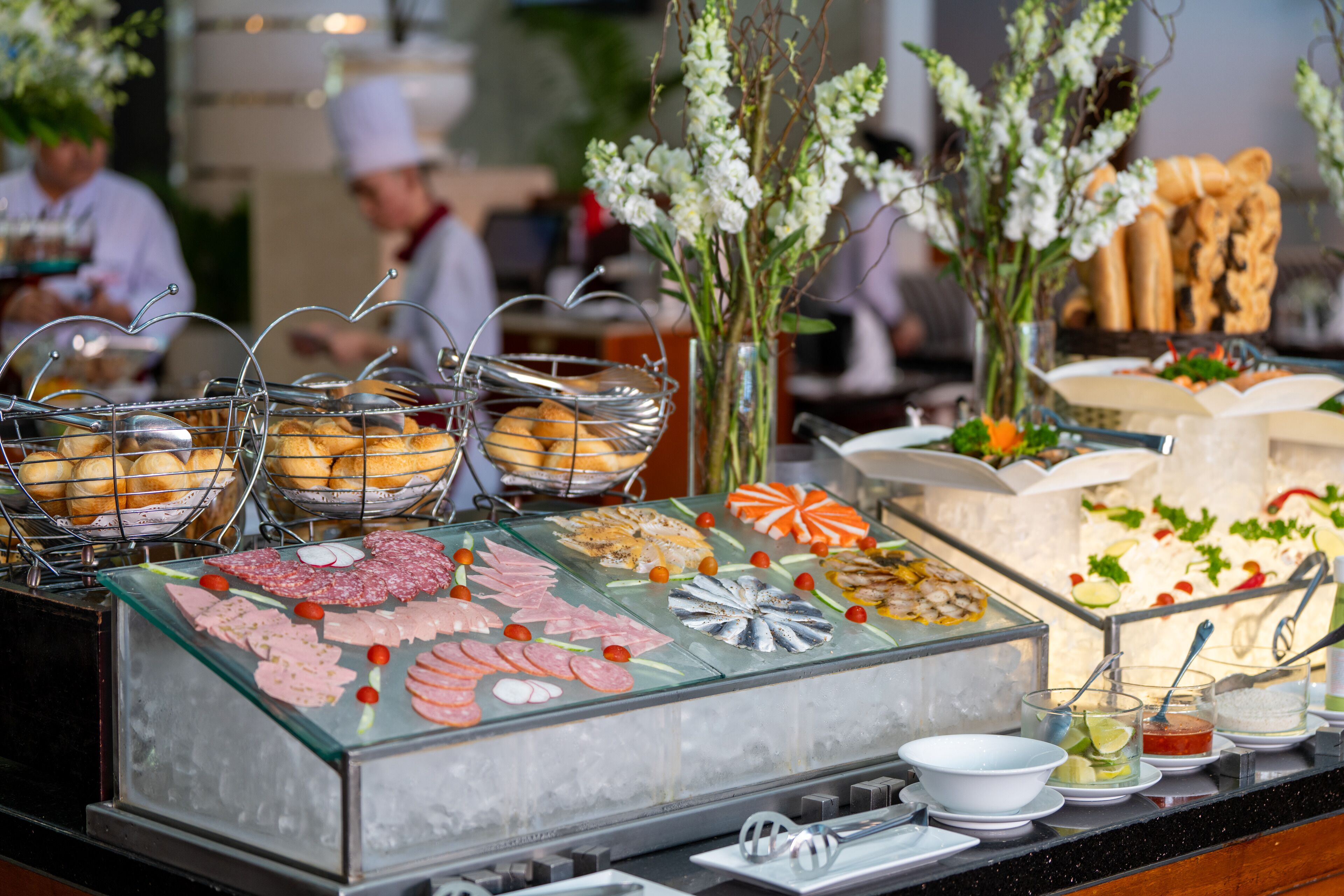 A buffet with various food items and a decorative vase.