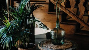 A staircase with wooden railings and a potted plant on the floor. - Casal Santa Eulàlia Hotel (Santa Margalida)