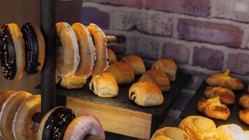 A display of various pastries including donuts and croissants.