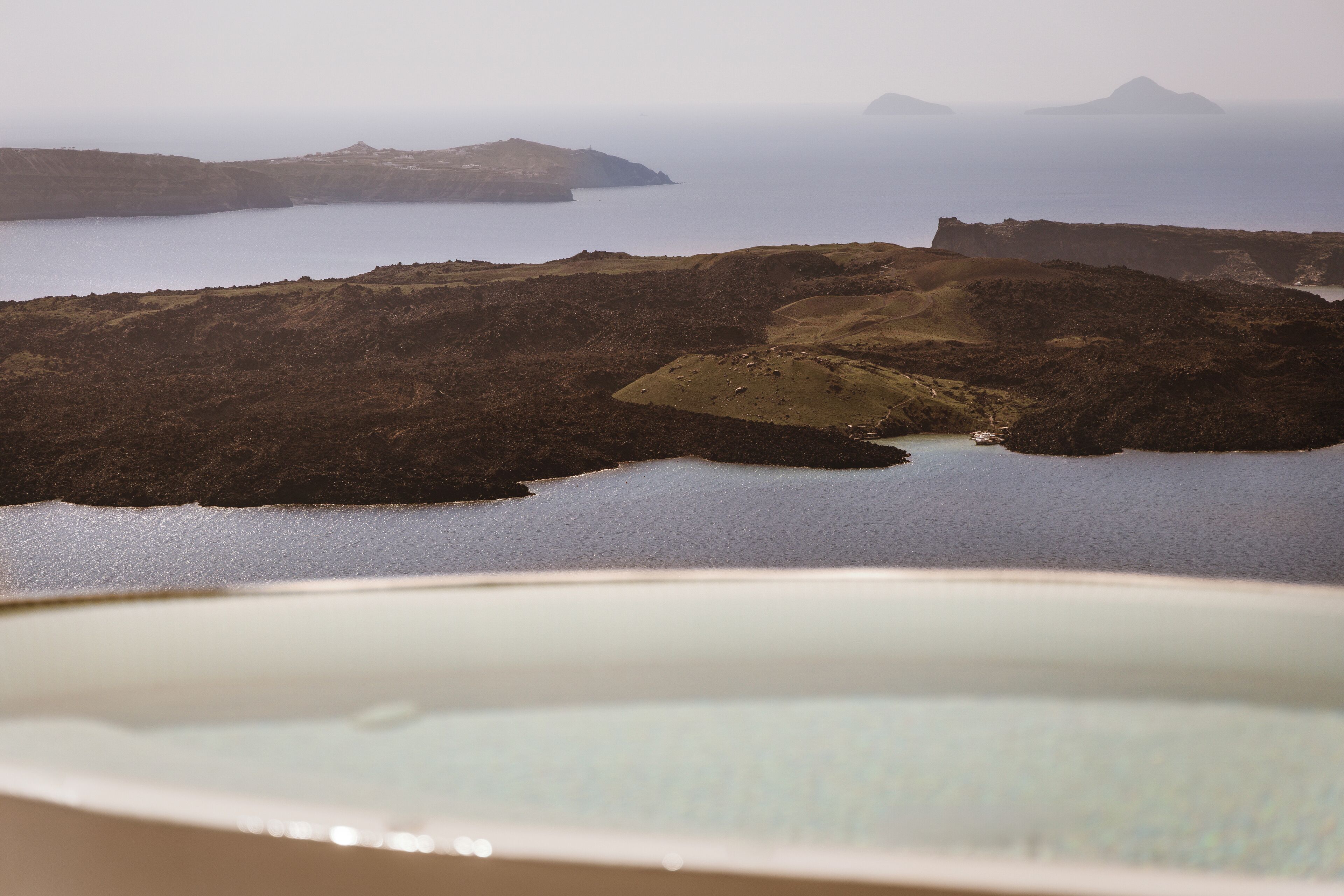 A coastal landscape with rocky terrain and a body of water.