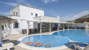 Relax by the pool surrounded by a shaded pergola and lounge chairs.