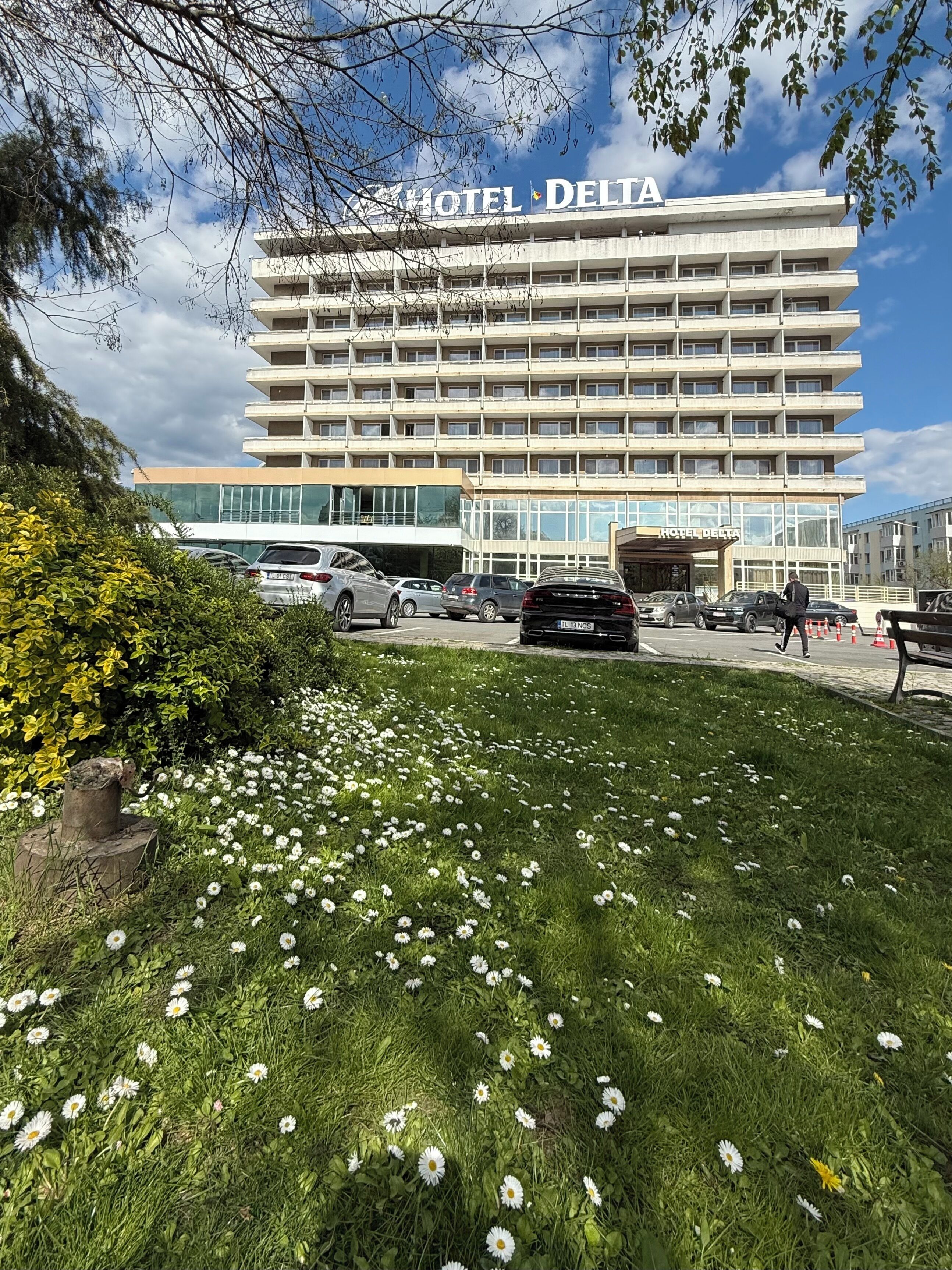 A multi-story hotel building with a sign reading 'HOTEL DELTA'.