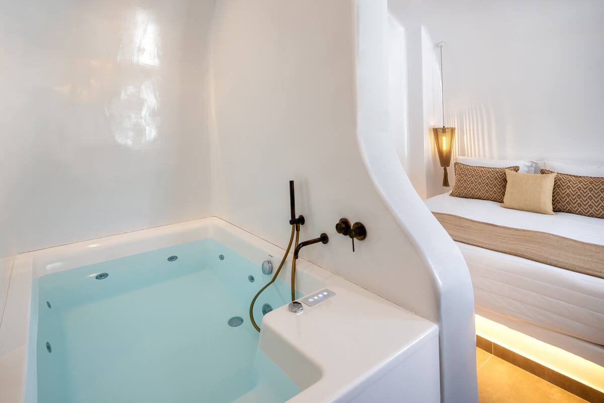 cave hot tub suite with pool view | bathroom | free toiletries, hair dryer, bathrobes, slippers