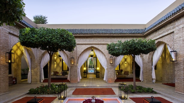 A courtyard with a central water feature, brick walls, and arches. - Riad Jawad & Spa (Marrakech)