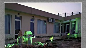 A building with a flat roof, large windows, and a stone pathway leading to the entrance. - Brigantina Beach (Varna)