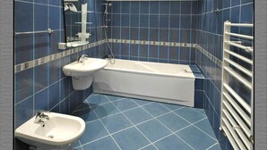 A bathroom with a bathtub, a sink, and a shower. - Brigantina Beach (Varna)