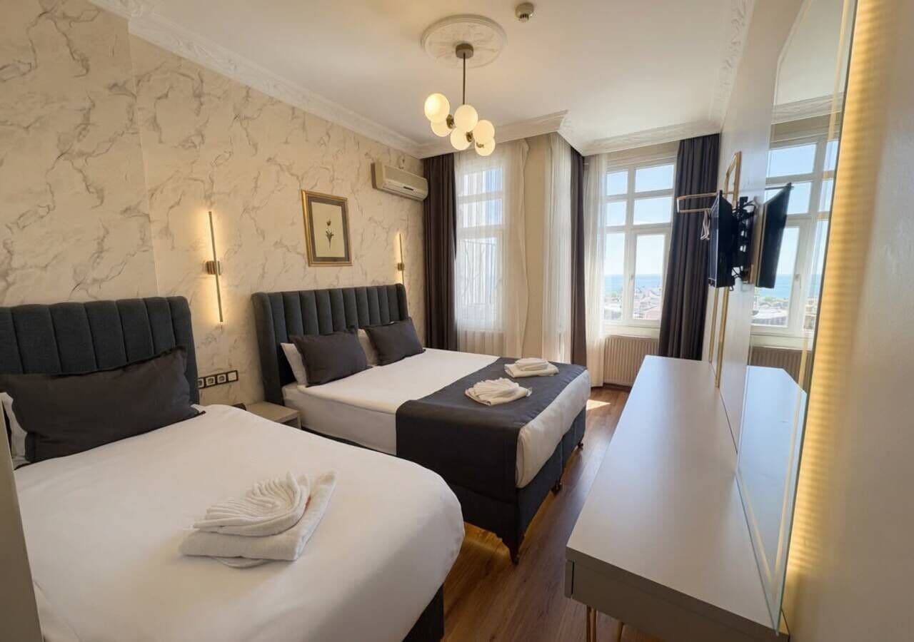Deluxe Triple Room, Sea View | Premium bedding, pillowtop beds, minibar, in-room safe